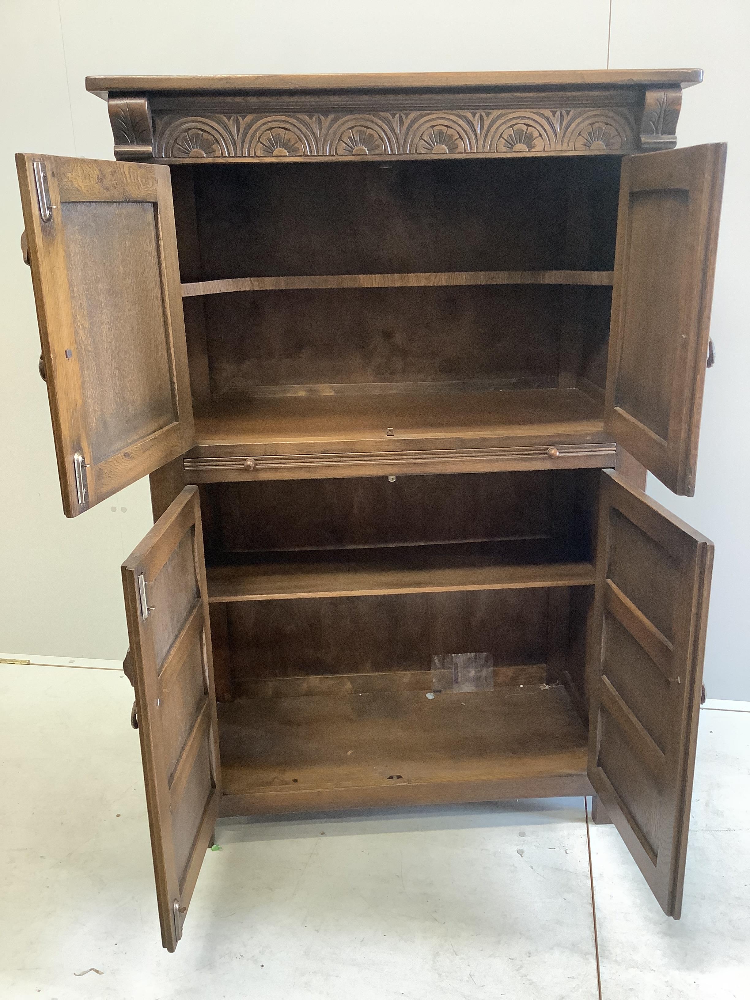 A Jacobean Revival oak cocktail cabinet, width 94cm, depth 49cm, height 139cm